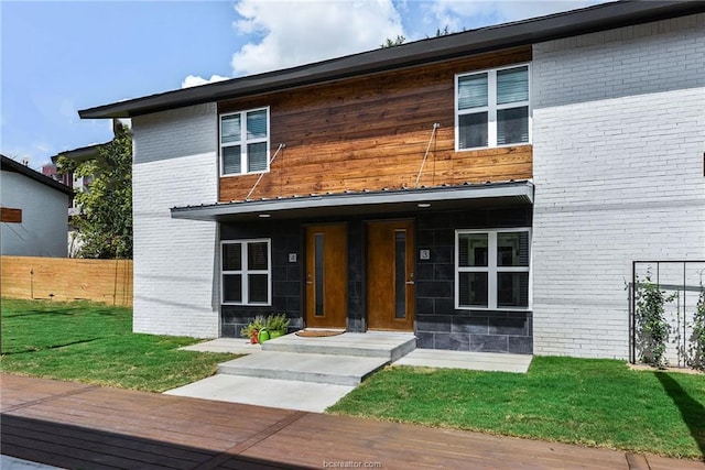 contemporary home featuring a front lawn