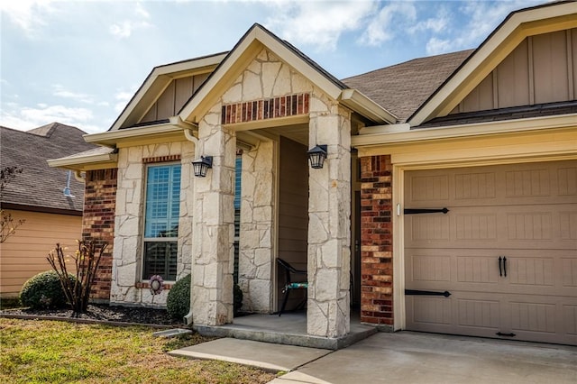 doorway to property with a garage