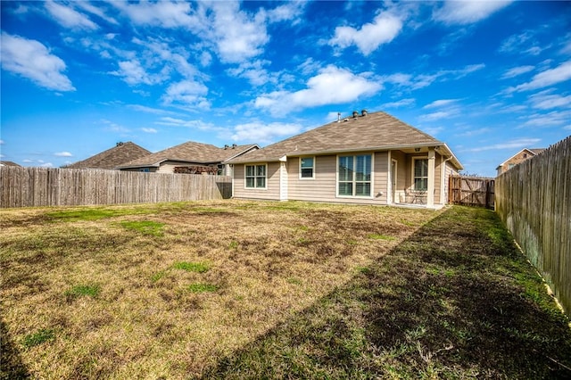 rear view of property with a yard