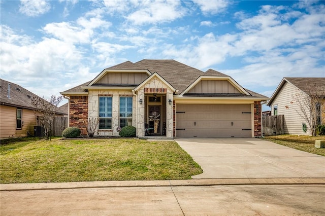 craftsman-style home featuring cooling unit, a front lawn, and a garage