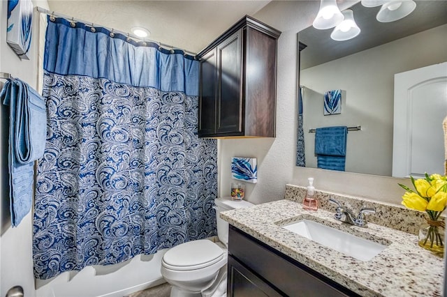 full bathroom featuring vanity, shower / bath combo, and toilet