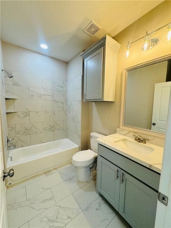 full bathroom featuring tiled shower / bath combo, vanity, and toilet