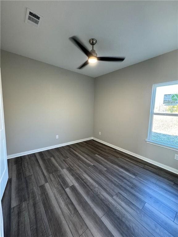 empty room featuring ceiling fan and dark wood-type flooring