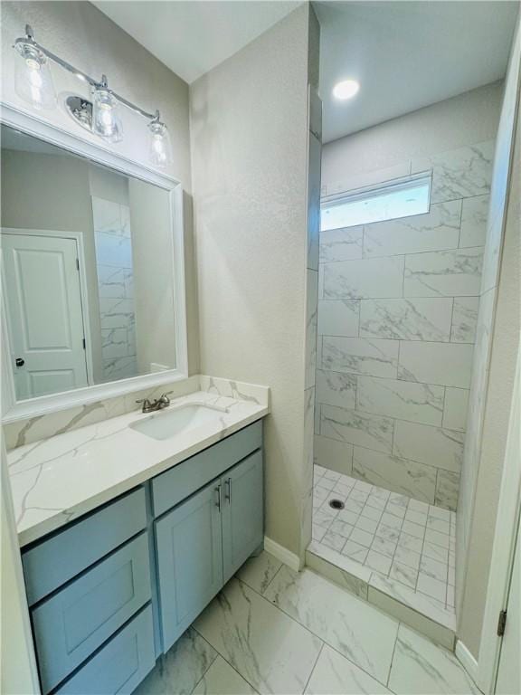 bathroom with vanity and a tile shower