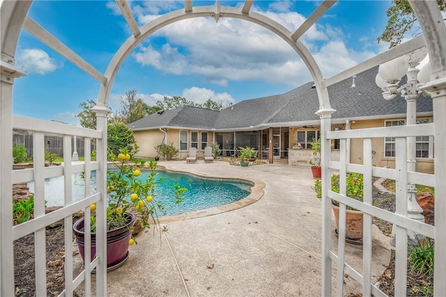 view of pool featuring a sunroom and a patio