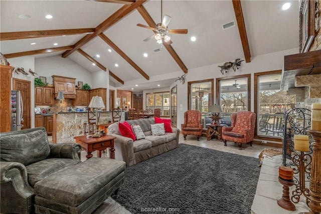 living room featuring beamed ceiling, ceiling fan, and high vaulted ceiling