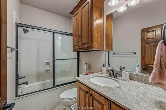 full bathroom with vanity, toilet, and bath / shower combo with glass door