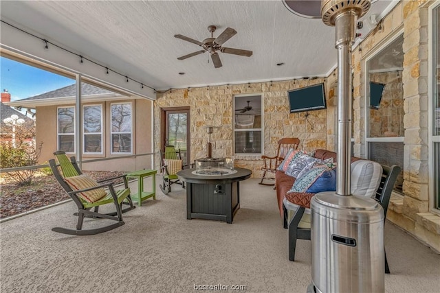 sunroom / solarium featuring ceiling fan