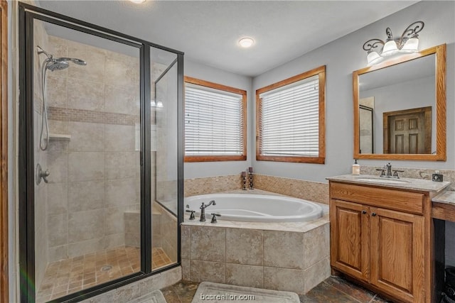 bathroom with shower with separate bathtub and vanity