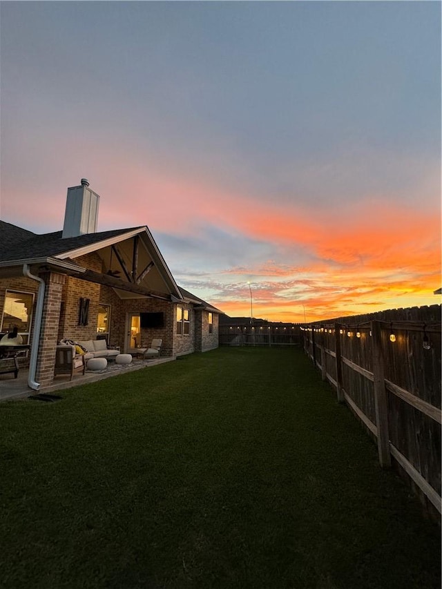 yard at dusk with a patio area