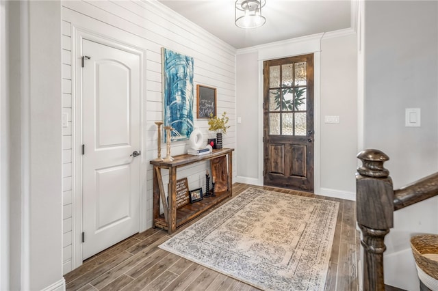 foyer with hardwood / wood-style flooring and ornamental molding