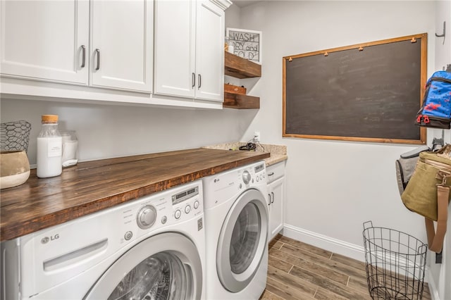 laundry room with cabinets, separate washer and dryer, and light hardwood / wood-style flooring