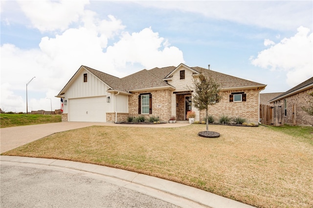 view of front of property featuring a front lawn and a garage