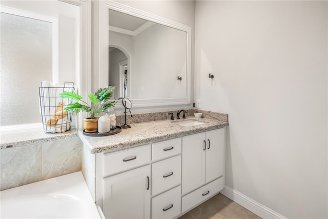 bathroom with vanity and ornamental molding