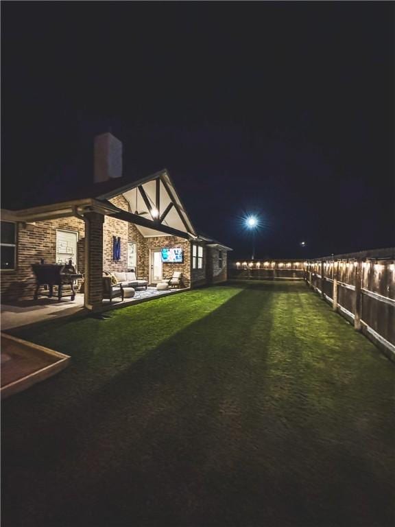 yard at twilight with a patio area