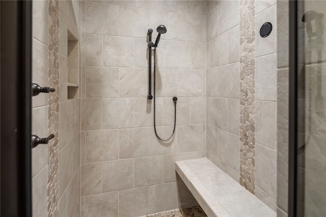 bathroom with a tile shower