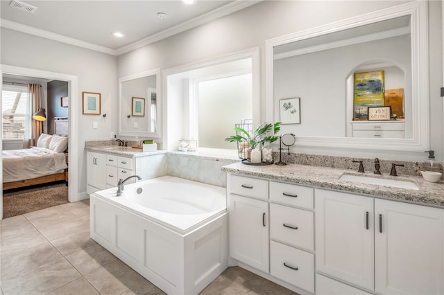 bathroom featuring ornamental molding, vanity, a washtub, and tile patterned floors