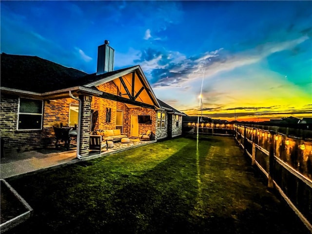 exterior space with a patio, an outdoor living space, and a lawn