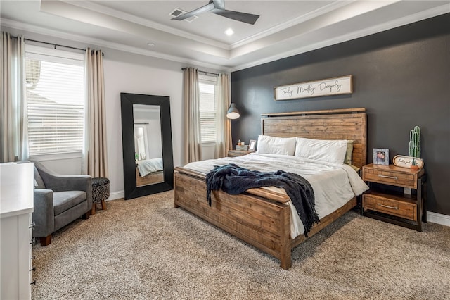 bedroom with a tray ceiling, ceiling fan, crown molding, and light colored carpet