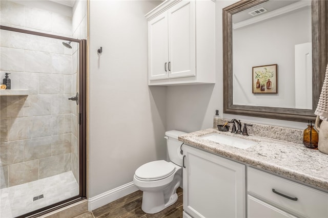 bathroom with toilet, hardwood / wood-style flooring, an enclosed shower, and vanity