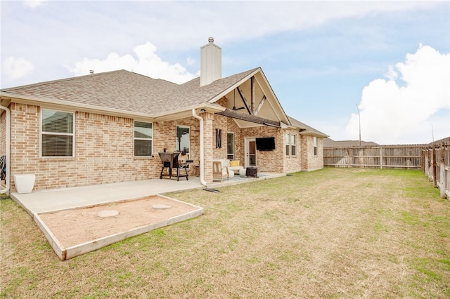 rear view of property featuring a patio and a lawn