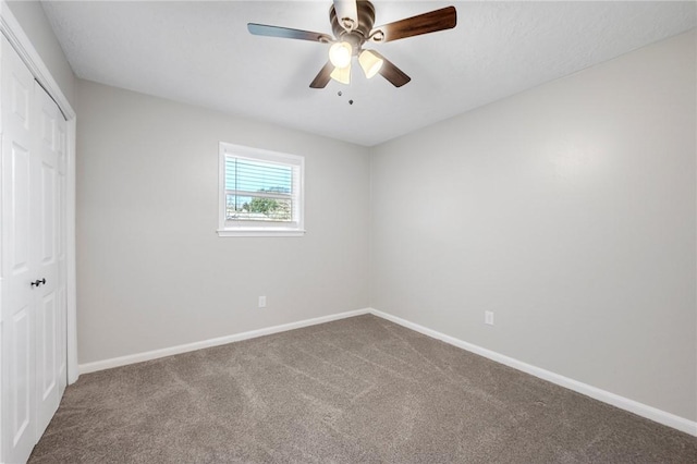 unfurnished room with ceiling fan and carpet floors