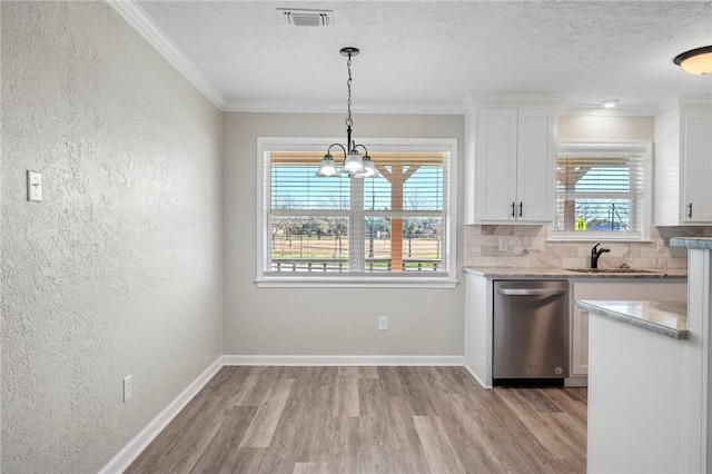 kitchen featuring dishwasher, white cabinets, ornamental molding, and sink