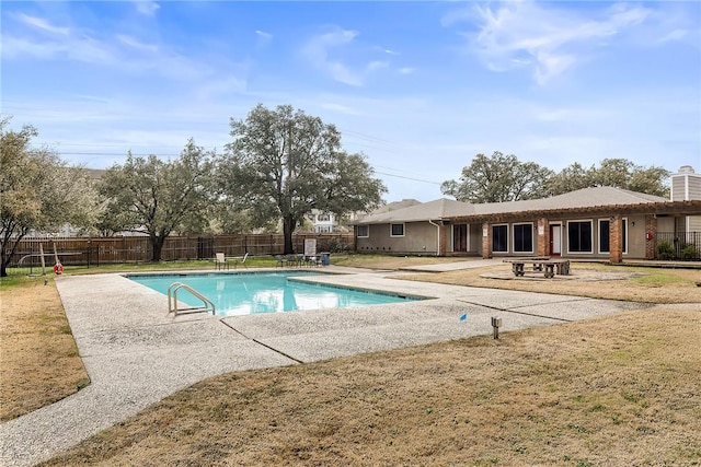 view of swimming pool featuring a patio and a lawn