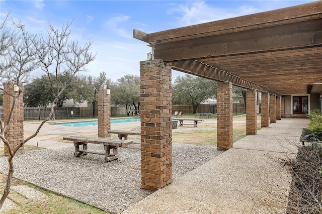 view of patio with a fenced in pool and a pergola