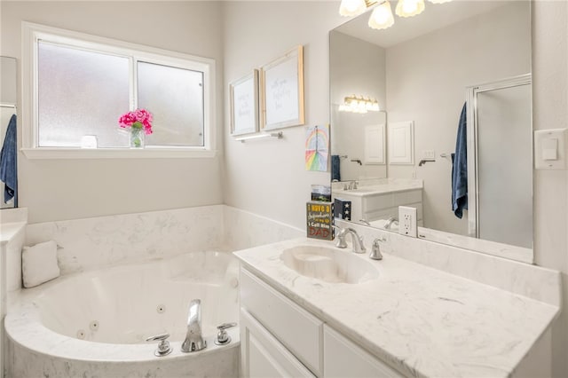 full bath with a tub with jets and vanity