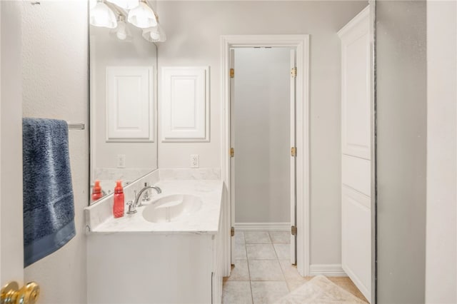 bathroom with tile patterned floors, vanity, and baseboards