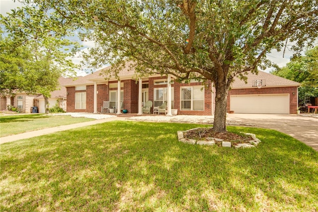 view of front of house with driveway, an attached garage, a front yard, and brick siding
