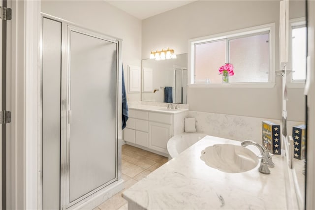 full bathroom with vanity, a shower stall, and tile patterned flooring