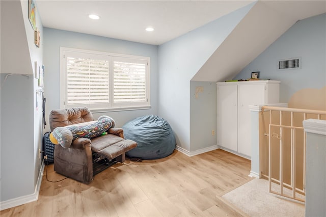 living area with recessed lighting, light wood finished floors, baseboards, visible vents, and lofted ceiling