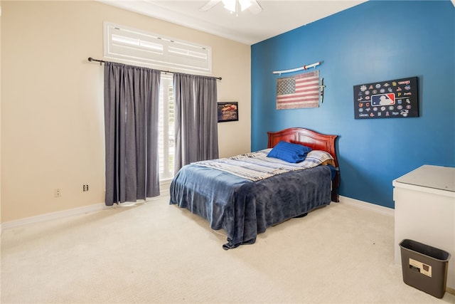 bedroom with a ceiling fan, carpet flooring, and baseboards
