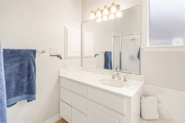bathroom with a shower stall and vanity