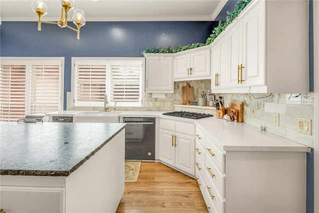 kitchen featuring gas cooktop, white cabinetry, stainless steel dishwasher, and a sink