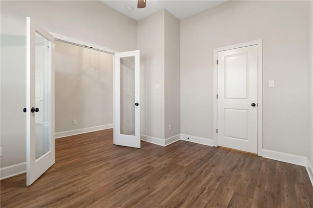 unfurnished bedroom featuring ceiling fan, dark hardwood / wood-style flooring, and french doors