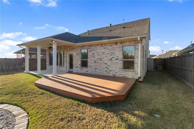 back of house with a lawn and a deck