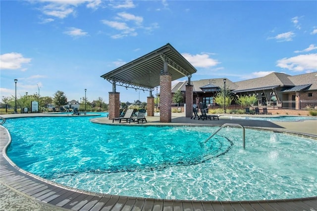 view of pool featuring pool water feature and a patio area