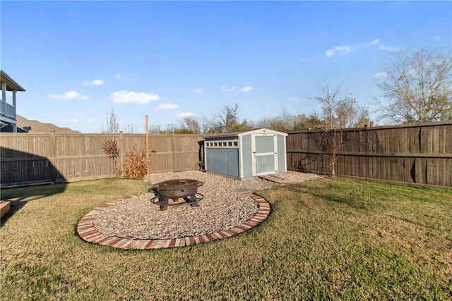 view of yard featuring a fire pit and a storage shed