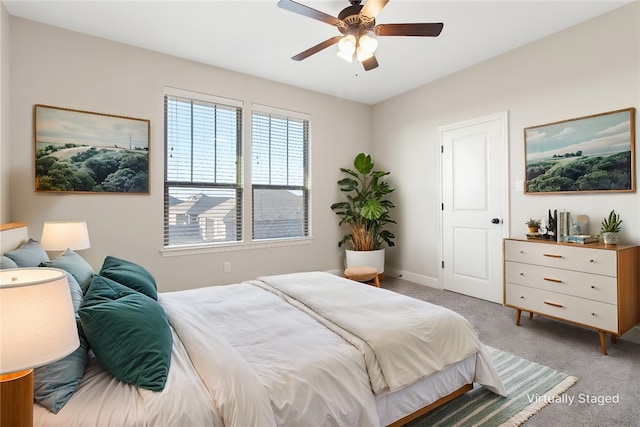 bedroom featuring light carpet and ceiling fan