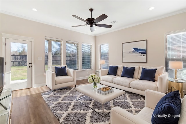 living room featuring light hardwood / wood-style floors, ceiling fan, and crown molding