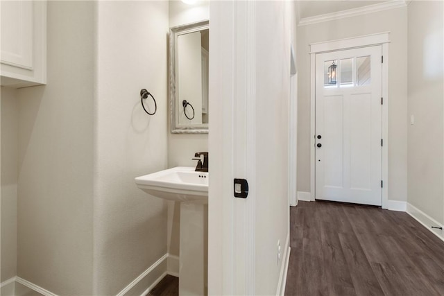 bathroom with hardwood / wood-style flooring and ornamental molding