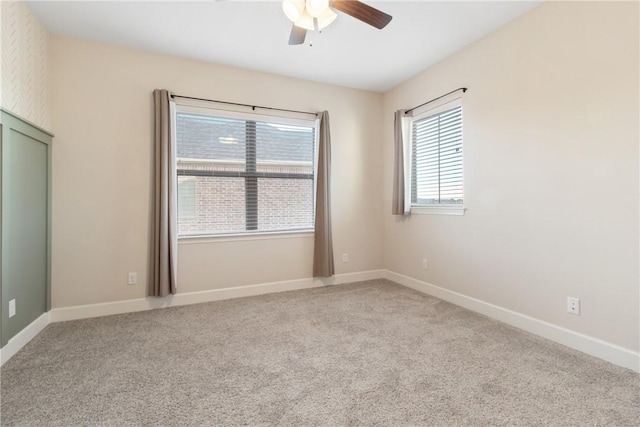 spare room featuring ceiling fan and light carpet