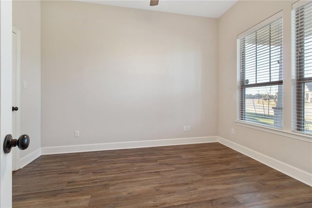 spare room with dark hardwood / wood-style flooring