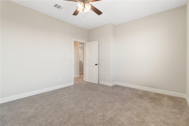 carpeted empty room featuring ceiling fan