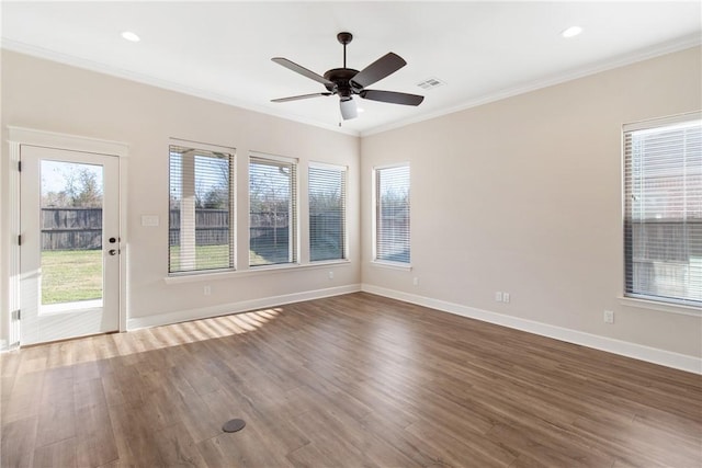 empty room featuring hardwood / wood-style floors, ceiling fan, and crown molding