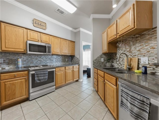 kitchen featuring dark countertops, visible vents, stainless steel appliances, and a sink