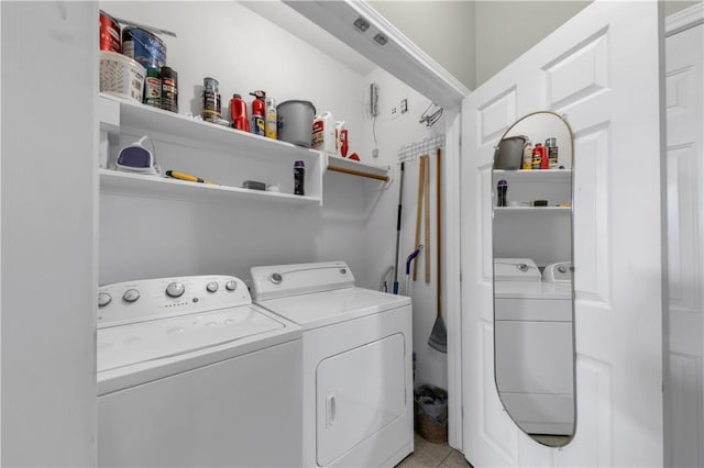 clothes washing area featuring washer and clothes dryer and laundry area